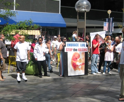 Anti-abortion protestors gather outside the hotel where Speaker Nancy Pelosi was appearing