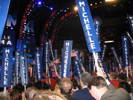 Convention goers wave Michelle banners during her speech